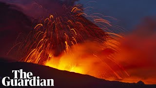 Mount Etna lights Sicilys night sky with red hot lava [upl. by Yltsew]